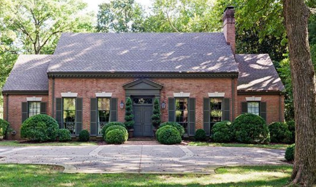 Red Brick Exterior with Classic Charcoal Shutters