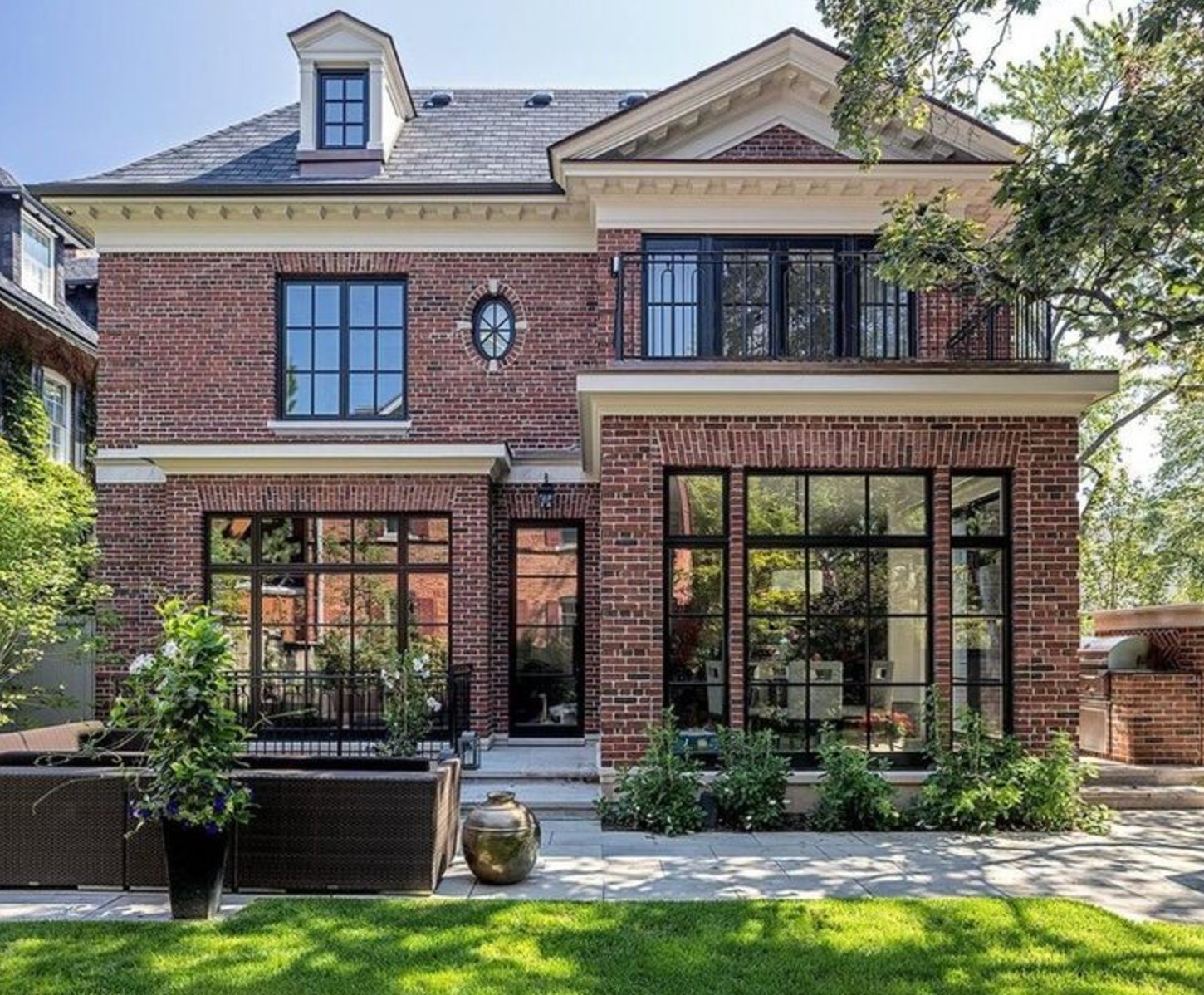 Red Brick Exterior with Dark Trim and Iron Accents