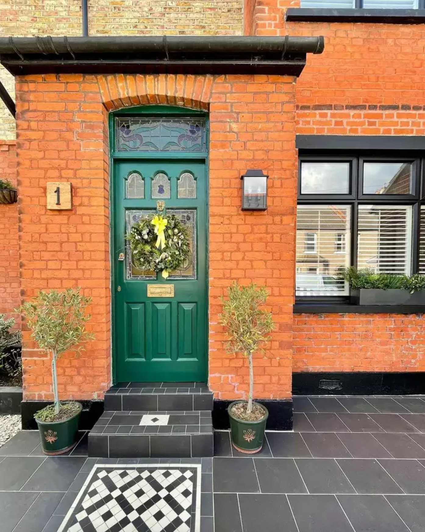 Red Brick Exterior with Forest Green Door