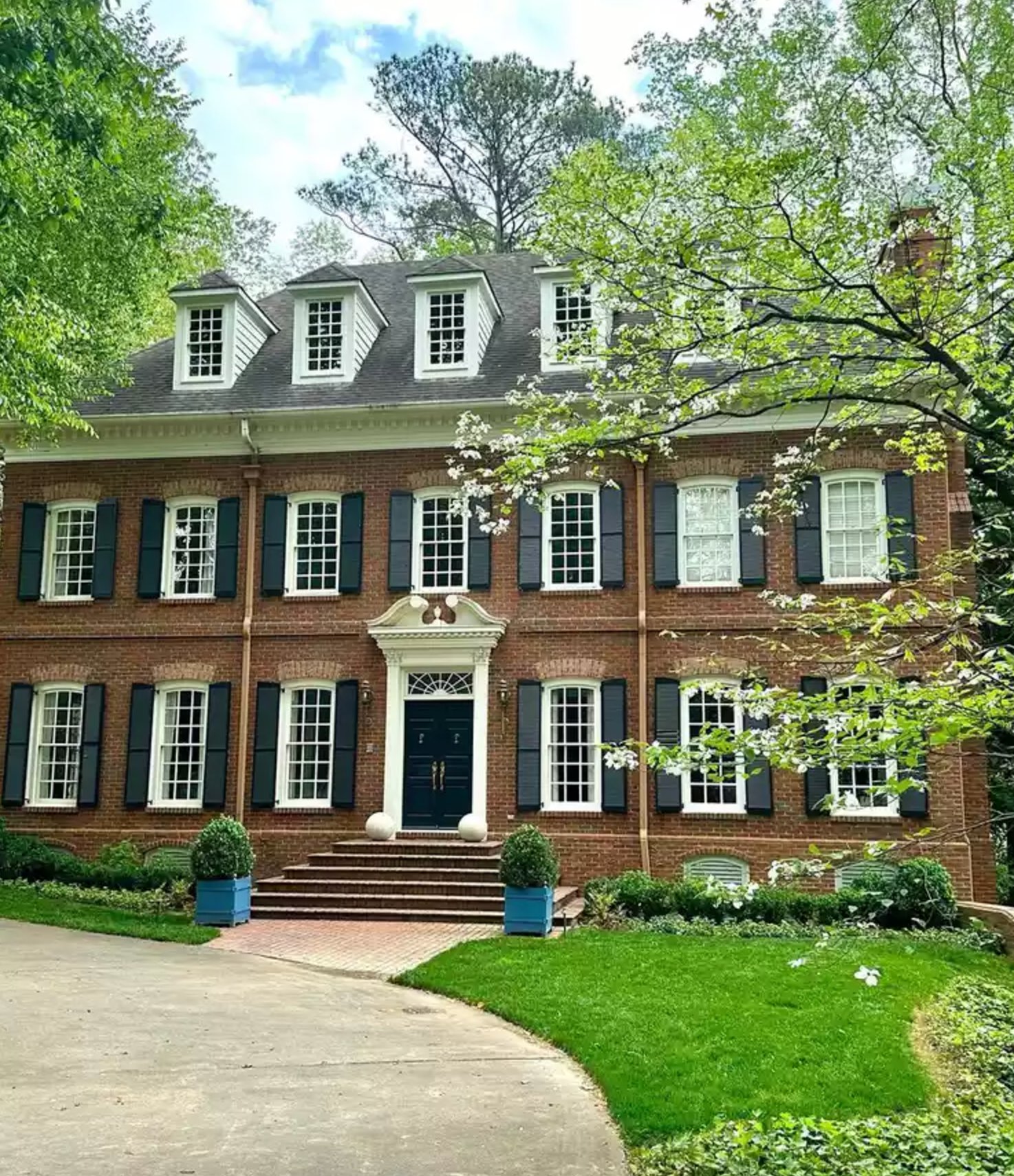 Red Brick Exterior with Navy Blue Shutters