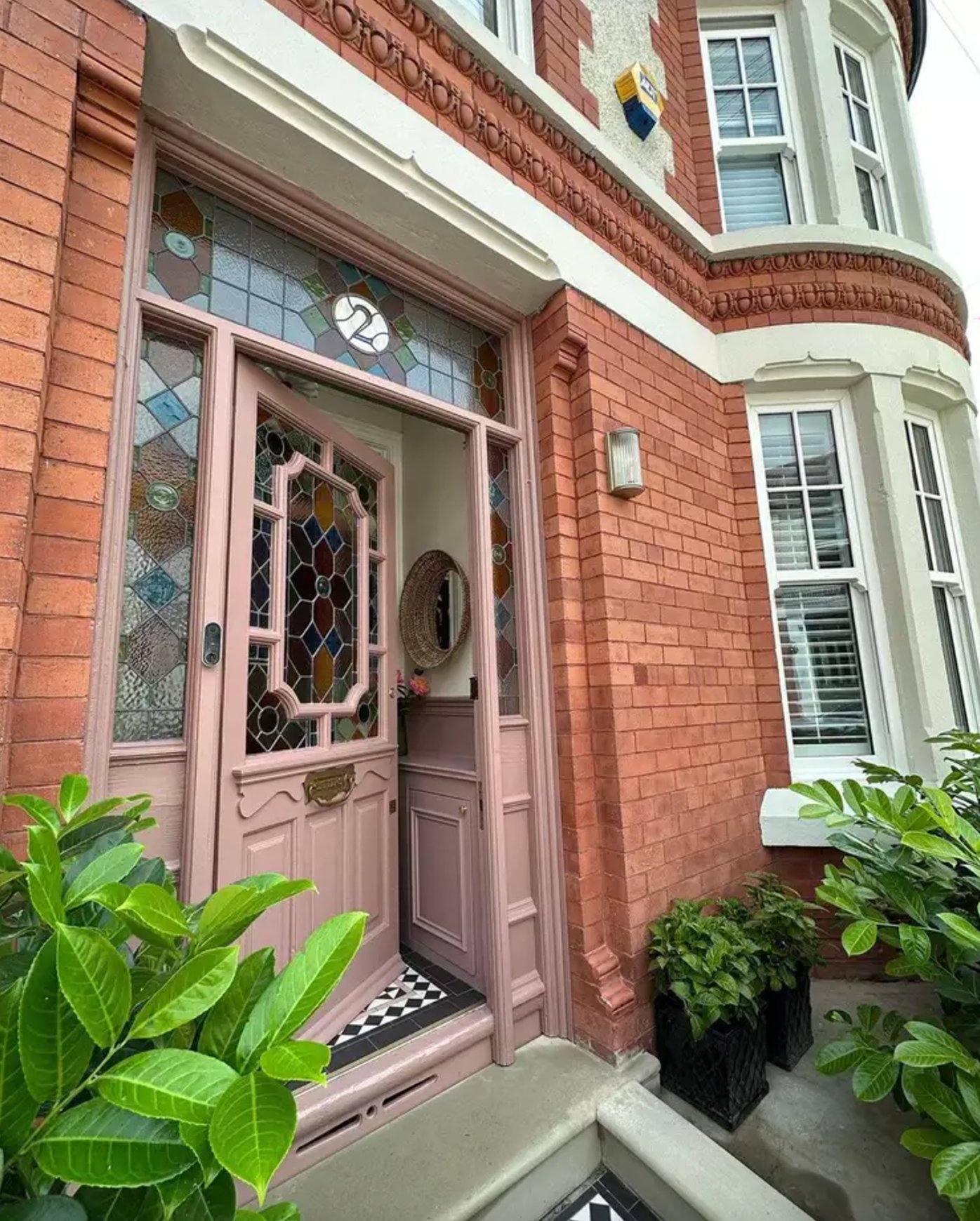 Red Brick Exterior with Blush Pink Door