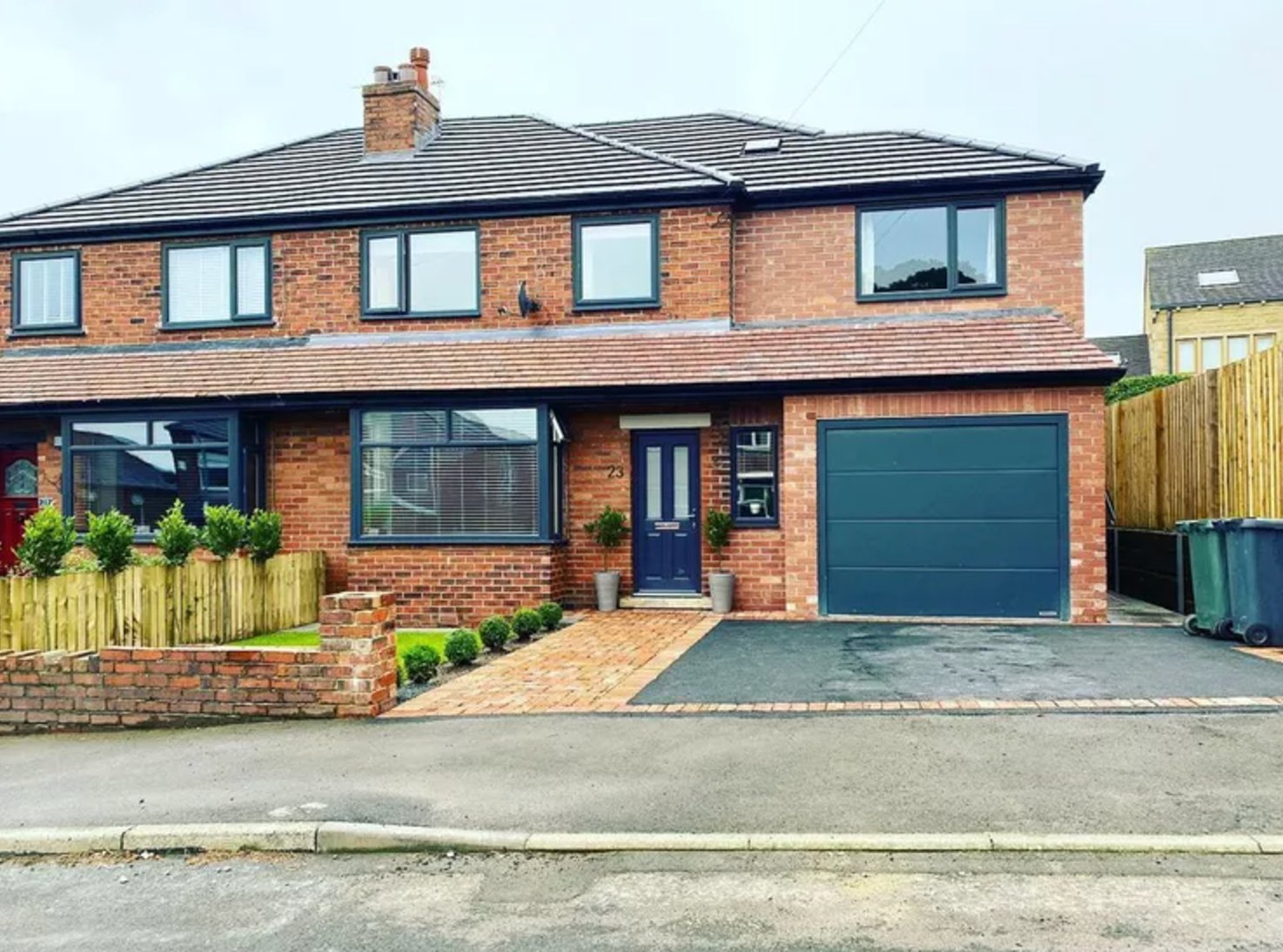 Red Brick Exterior with Modern Navy Pop