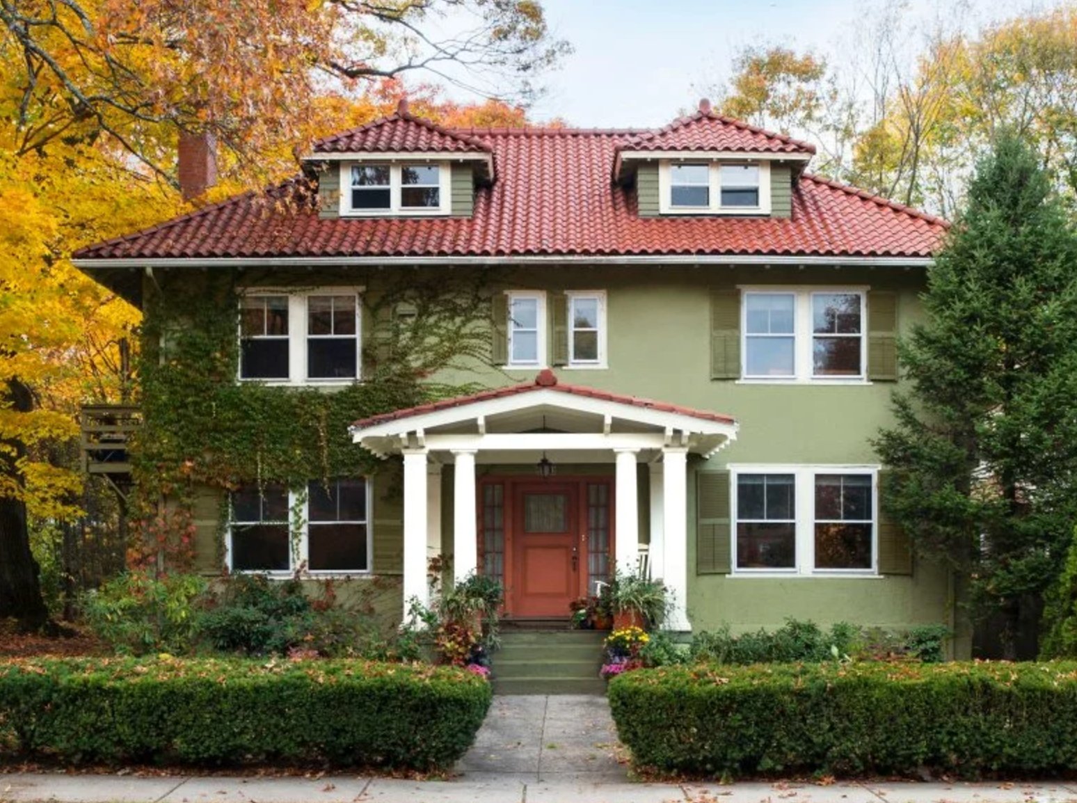 Sage green and red house exterior