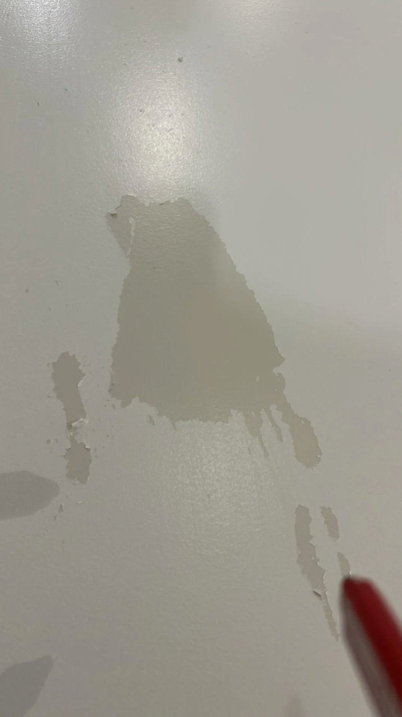 Water-based paint peeling from oil-based surface